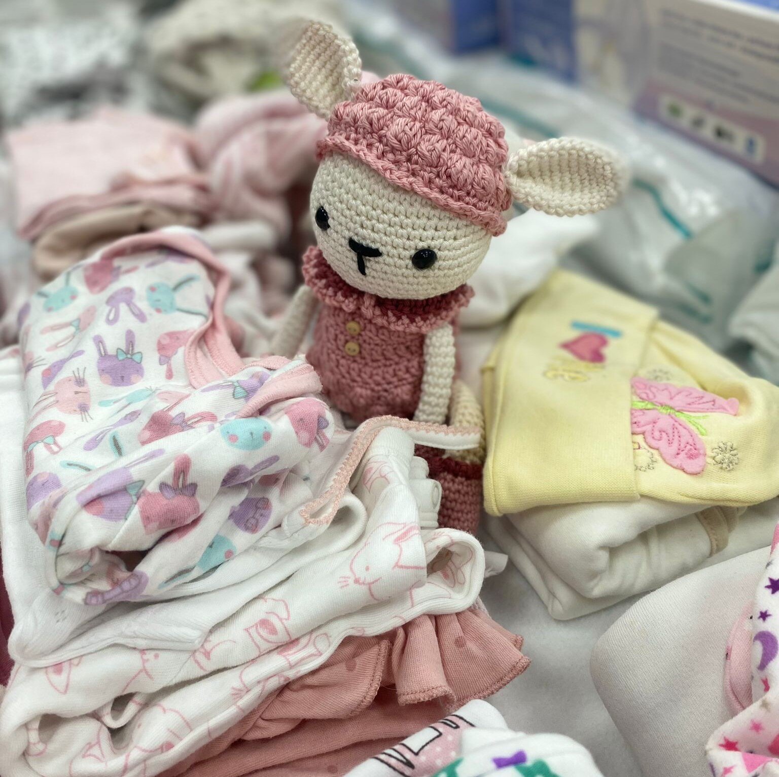 Folded babies clothes and toy bunny